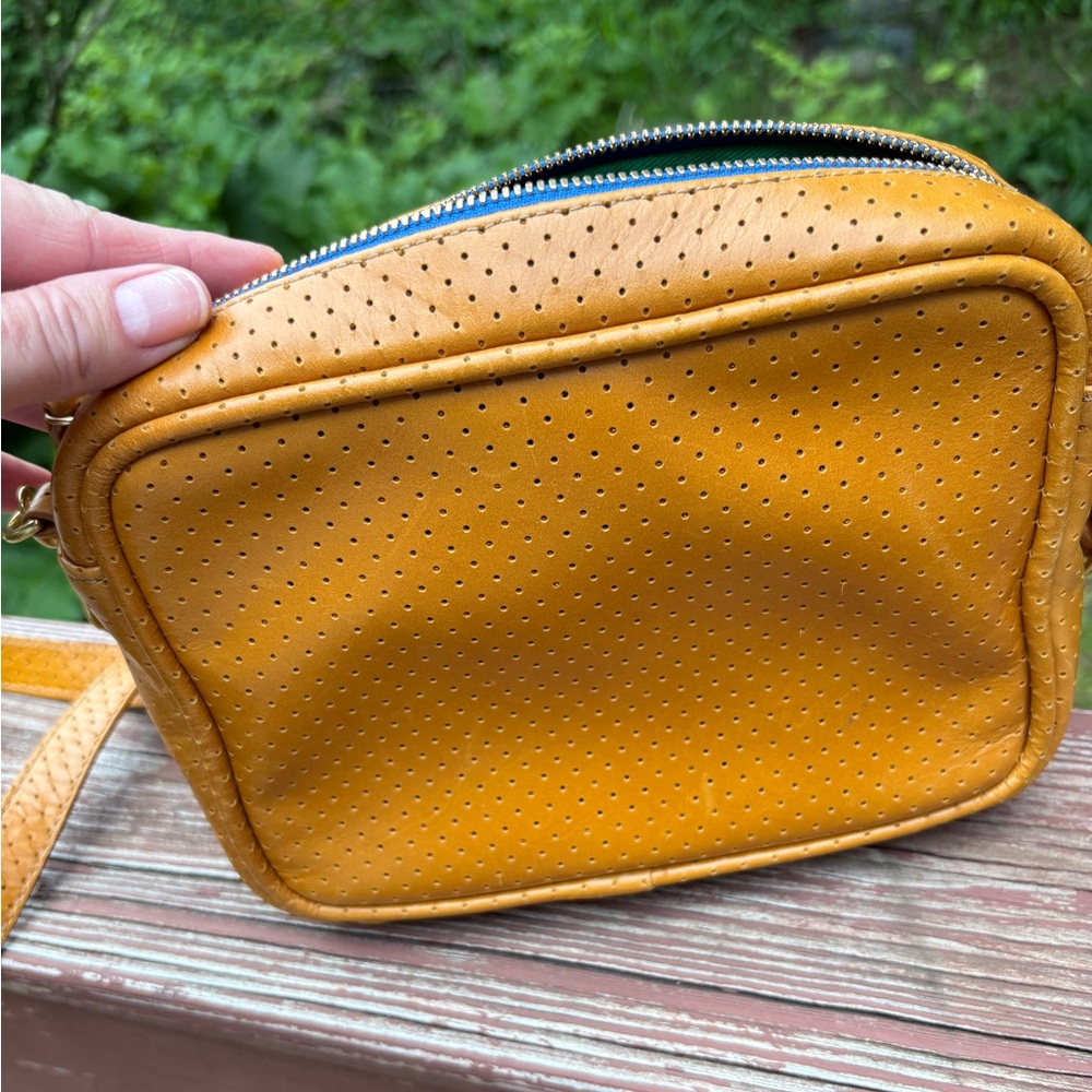 Blair Ritchey Ginger Ber Perforated Crossbody Bag with bright blue zipper.